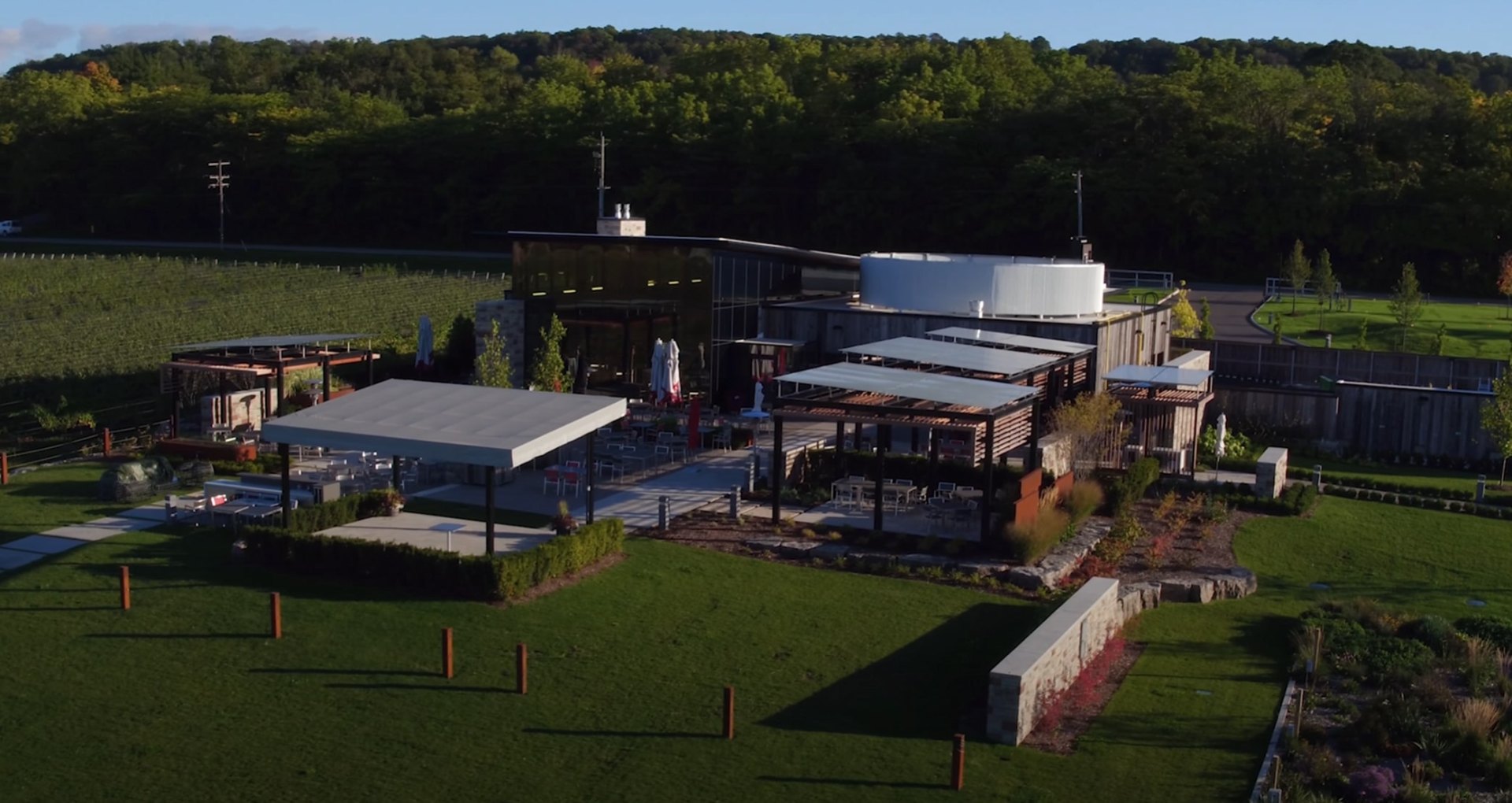 Commercial landscape maintenance showcasing modern architectural integration with sustainable turf management Modern commercial landscape with geometric building design, maintained lawns, and professional hardscaping elements